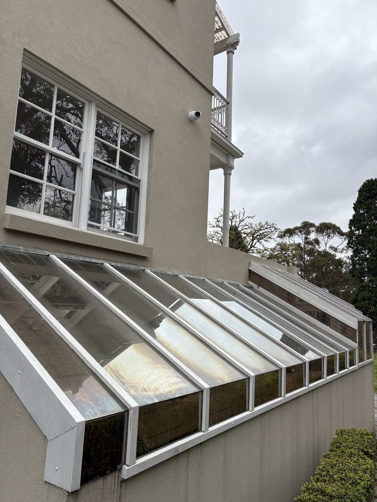 Conservatory before cleaning — grimy glass